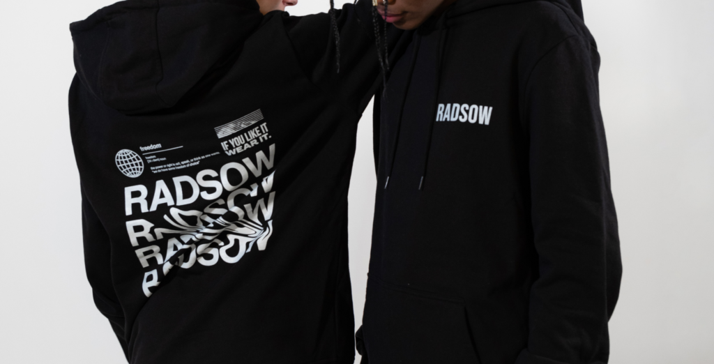 Two people model hoodies, with a small logo on the left chest, and a large one on the back