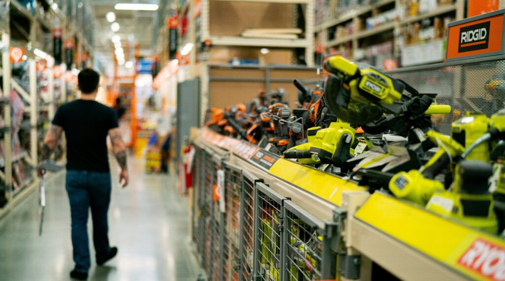 A man walks down the aisle at a hardware store