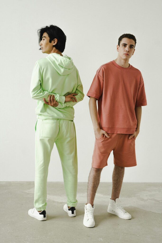 Two young people pose in sweatsuits