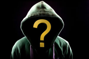 A person wearing a hoodie where you cannot see their face, but a question mark instead