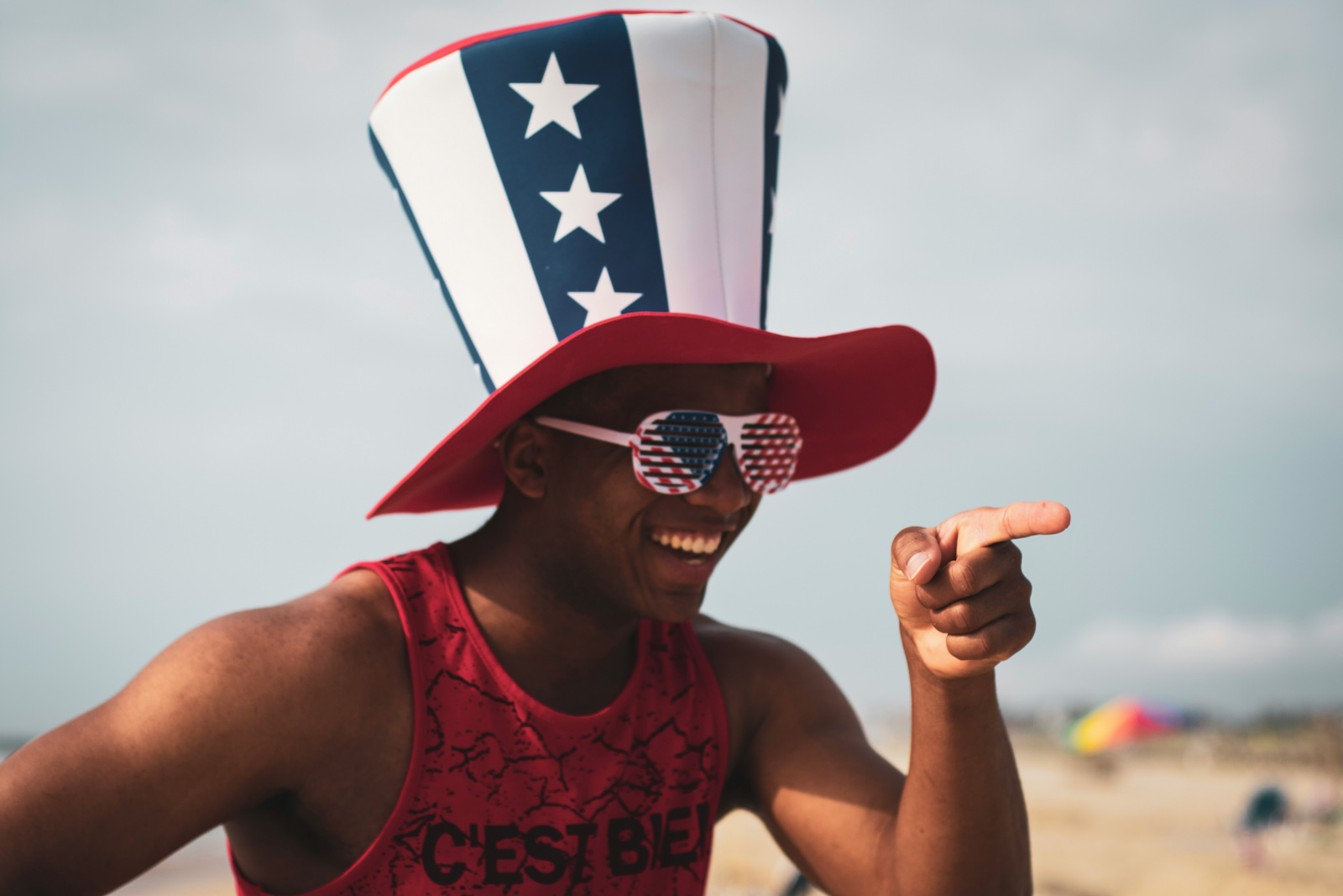 A man wearing US flag-themed sunglasses and hat