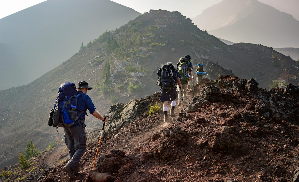 People hiking in the mountains with backpacks