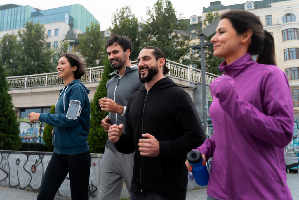 4 people jogging while wearing athleisure- casual sports clothing