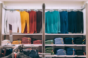 Lots of folded clothes on shelves in a store