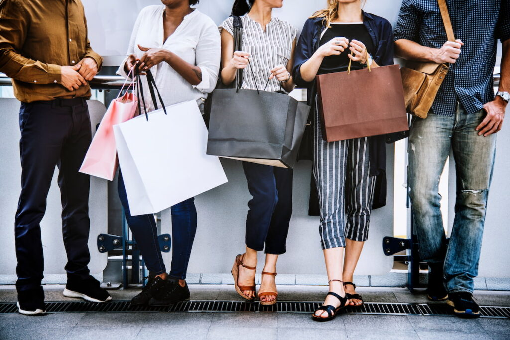 A group of people carrying shopping bags